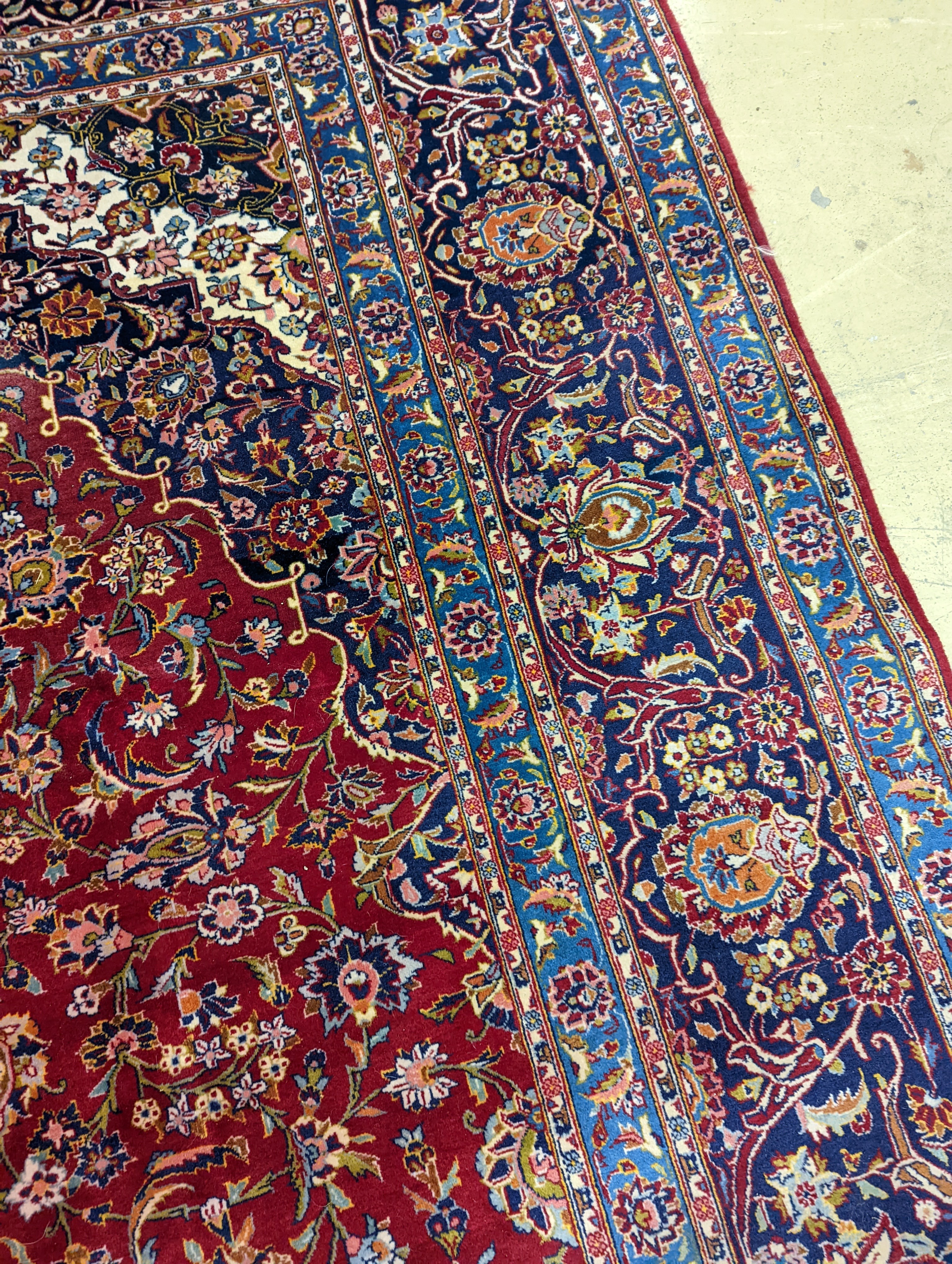 A large Tabriz red ground floral carpet, 540 x 350cm